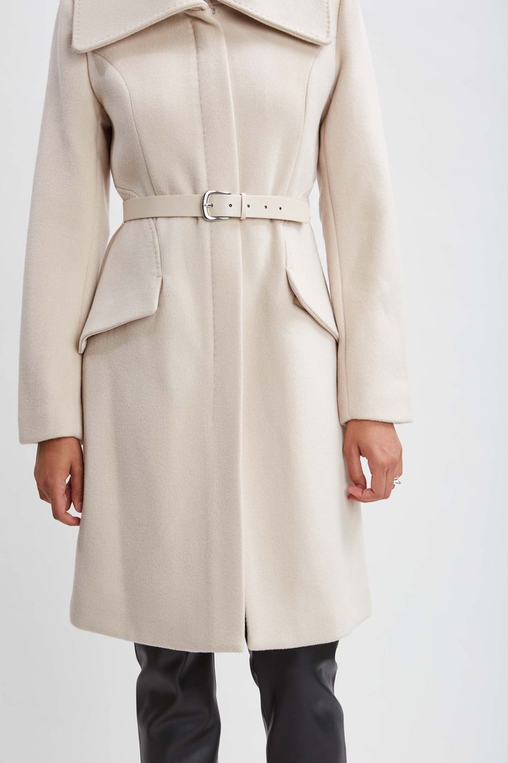 Wrap up this season in our chic belted coat done in a warm double face wool. This sophisticated fully lined coat makes a cold weather statement featuring an oversized collar, contour seams and vegan leather belt; the silhouette is a modern twist on a classic, setting a new standard in outerwear. Elie Tahari Exclusive Panel Wool Coat with Vegan Leather Belt & oversized collar 80% Wool, 15% Nylon, 5% Cashmere Runs true to Size Length From Shoulder to Hem: Back 38.5"L, Sleeve: 33"L (approx. length Chic Fitted Wool Coat With Belted Cuffs, Luxury Belted Wool Coat For Office, Chic Wool Long Coat, Chic Belted Pea Coat With Lapel Collar, Luxury Belted Wool Office Coat, Elegant Beige Outerwear With Concealed Fastening, Chic Wool Coat With Concealed Front Fastening, Chic Wool Coat With Belted Cuffs And Lapel Collar, Formal Belted Beige Wool Coat