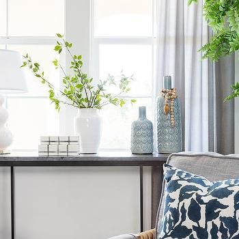 a living room filled with furniture and plants