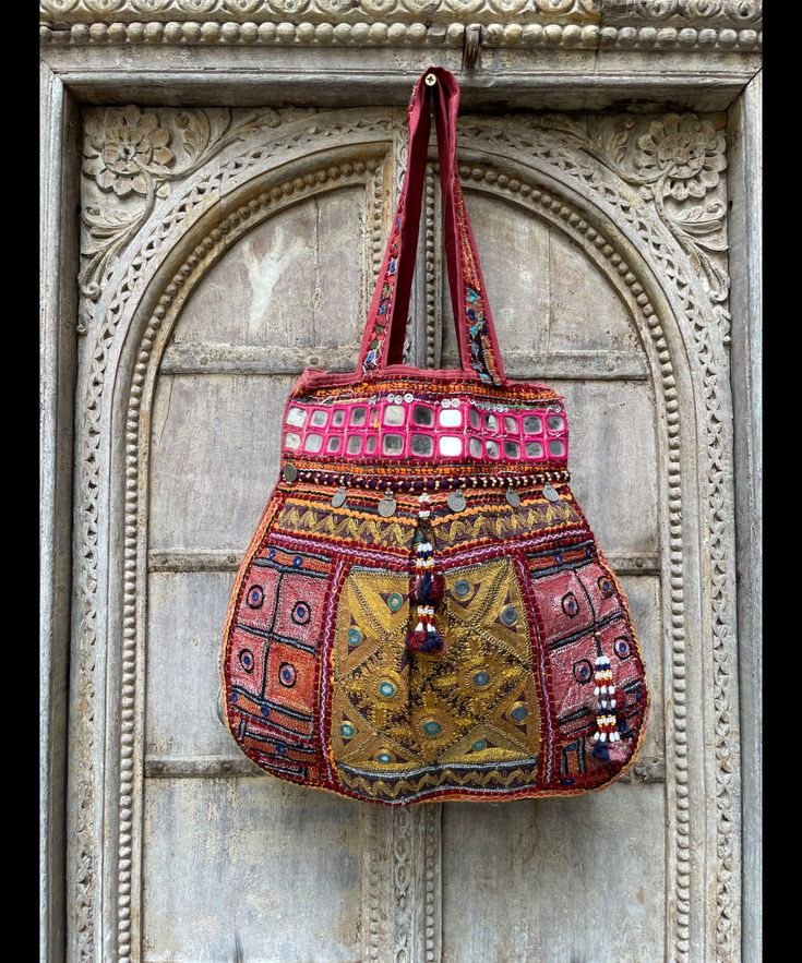 About bag  Indo-gypsy fusion, everyday use hand bag made from Banjara fabrics sourced from Vintage tribal costumes of regions of Rajastan and Gujarat. These are embellished with light catching coins, and intricate bead work tassels. Size - length 15 inches/ width 21 inches Company details:  Company name: Houseoftextile  Contact number: +919784447473  Email id: houseoftextile77@gmail.com  Shipping & custom : Delivery through one of the finest service providers : Skyway, Fedex, UPS  And DHL. Any l Rectangular Handwork Festival Bag, Bohemian Multicolor Potli Bag For Festive Occasions, Bohemian Multicolor Potli Bag For Festive Season, Multicolor Bohemian Potli Bag For Festive Occasions, Bohemian Rectangular Potli Bag For Festive Season, Festive Multicolor Tote Bag, Festive Bohemian Rectangular Potli Bag, Festive Embroidered Tote Bag, Festive Multicolor Rectangular Bags