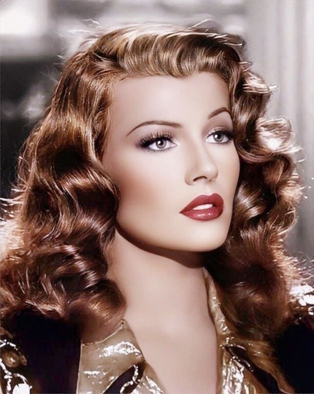 a close up of a mannequin head wearing a gold dress and red lipstick