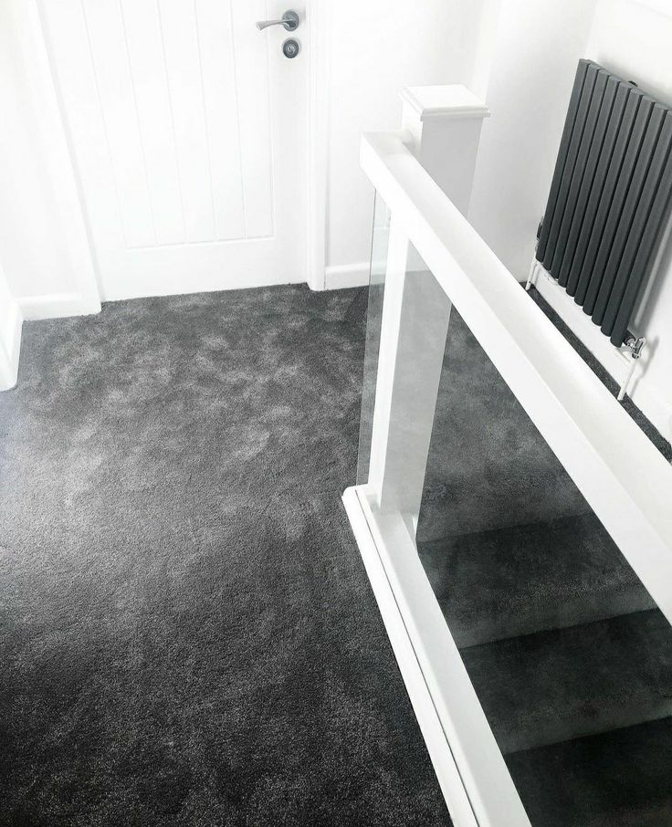 a black and white photo of a room with a radiator on the wall