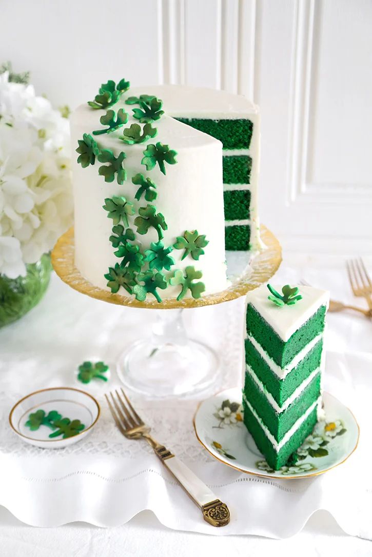 there are two pieces of green cake on the plate and one slice is missing from it