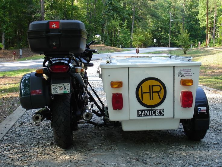 a motorcycle is parked next to a truck