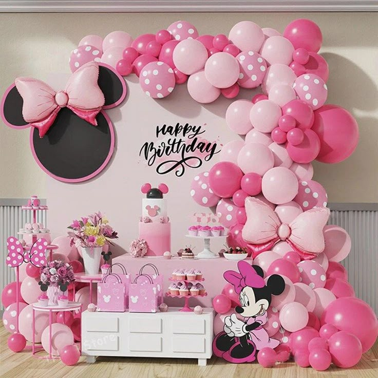 a minnie mouse birthday party with balloons and decorations