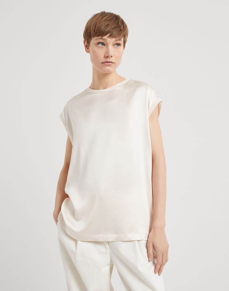 Stretch silk satin T-shirt with monili The iconic embellishment of the Brunello Cucinelli collections defines the style of this stretch silk satin T-shirt, an essential womenswear piece. The fabric’s glossy texture is combined with a shiny monili detail. The small button closure at the back of the neck makes it easy to wear the garment, which offers a comfortable fit and slightly dropped shoulders. Satin T Shirt, Eyewear Womens, Boutique Online, Shirt Skirt, Blazer Dress, Event Dresses, Denim Pant, Brunello Cucinelli, Shirts & Tops