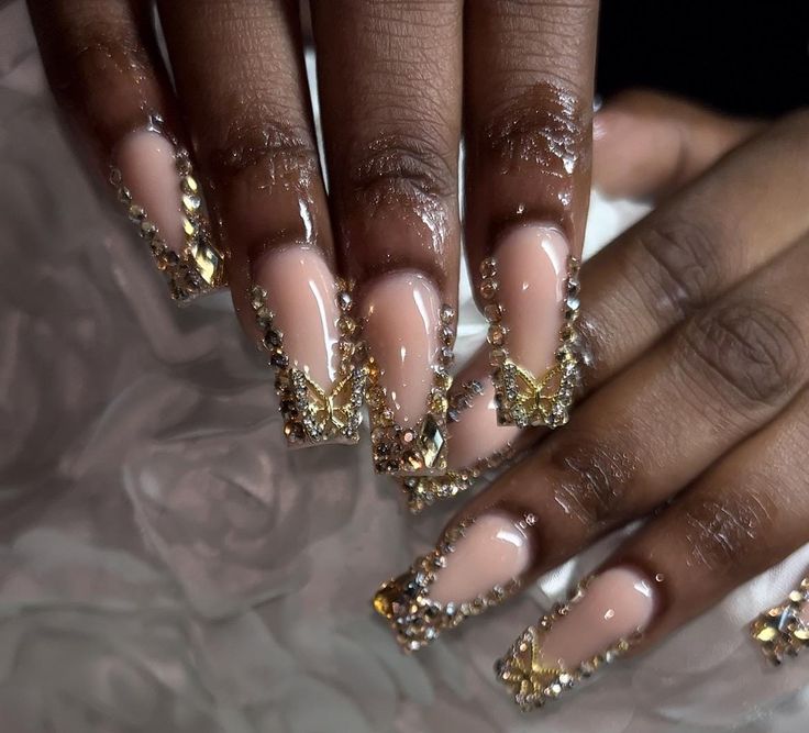 Full gold bling french tips with matching butterfly charms Gold Bling French Tip Nails, All Gold Nails, Birthday Nails White And Gold, White Nails With Gold Rhinestones, Gold Yellow Nails, Gold And Royal Blue Nails, Latina Acrylic Nails Gold, Gold Gem Nails, Gold Butterfly Acrylic Nails