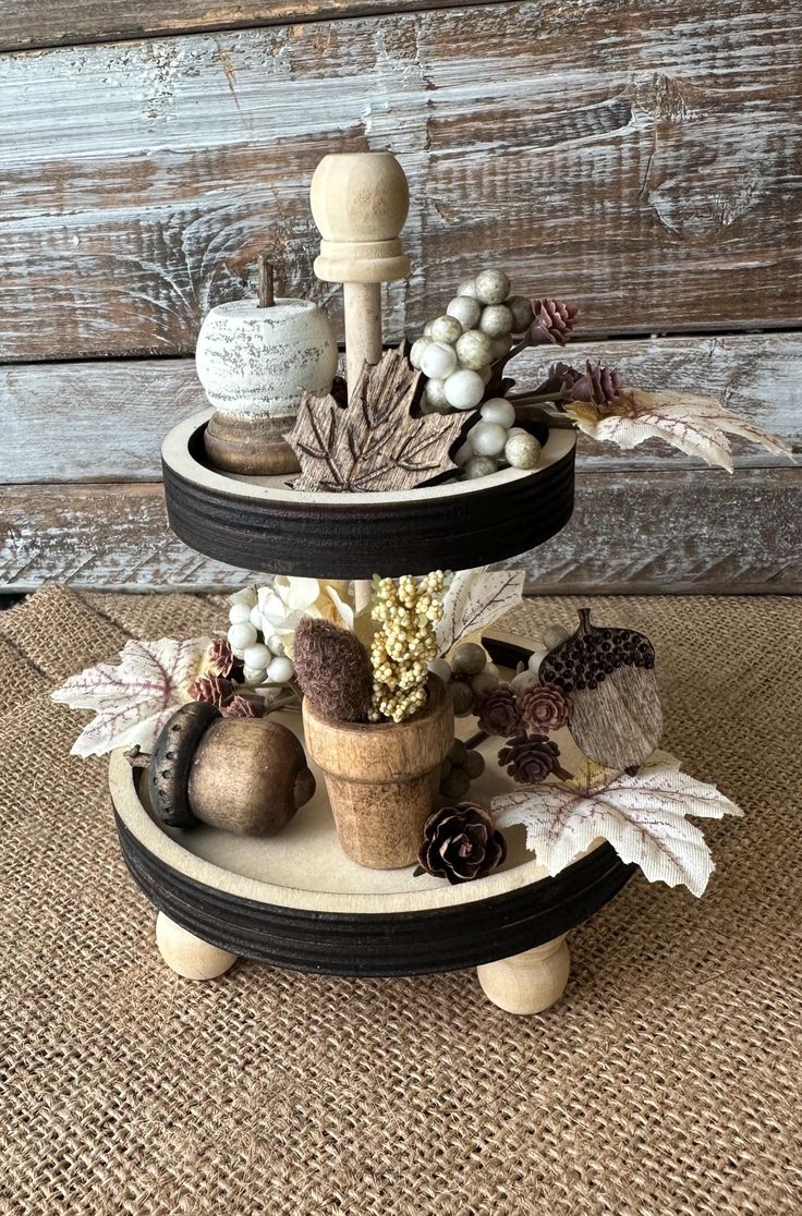 two tiered trays with autumn decorations on them