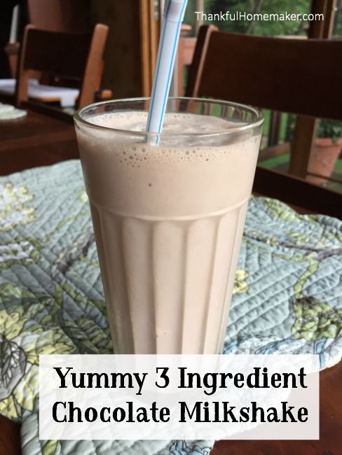 yummy 3 ingredient chocolate milkshake in a tall glass with a blue straw