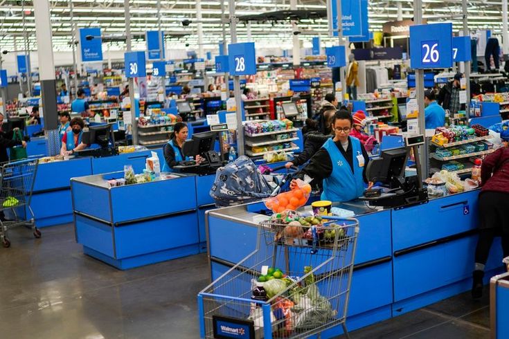 people shopping in a store with blue counters