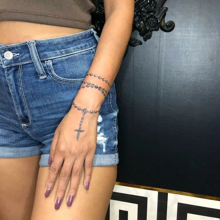 a woman with a cross tattoo on her arm