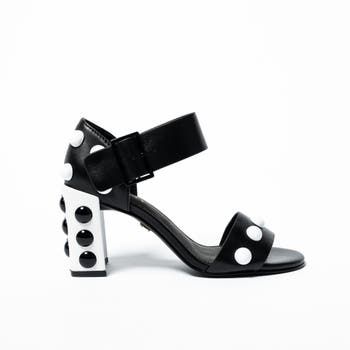 Supersized  studs inspired by Roman palace architecture shine boldly on this block heel of this ankle-strap leather sandal. 8 1/4" Heel Ankle Strap Closure Fits True to Size Leather Upper and Lining Luxury Stacked Heel Block Heels For Summer, Luxury Block Heels With Stacked Heel For Summer, Bold Sandals With Heel And Ankle Strap, Formal Ankle Strap Sandals With Studded Rubber Outsoles, Chic Ankle Strap Sandals With Studs, Designer Ankle Strap Sandals With Studs, Designer Studded Open Toe Heels, Designer Open Toe Heels With Studs, Bold Block Heel Sandals With Strap