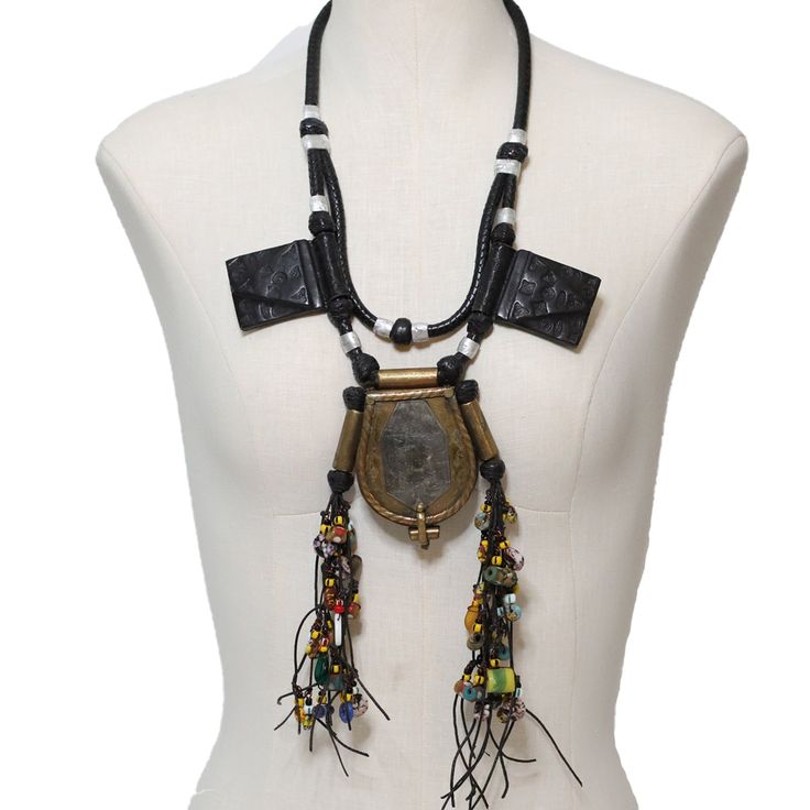 Unisex one of a kind protective custom Tuareg tribal wearable art pouch necklace. Handmade out of brass, aluminium, cooper, leather and recycled glass. This amulet necklace has a pouch to put sacred religious readings for good luck and happiness. After you wear our necklace with pride, please hang it on a wall. This is a great wall decor and conversation artifact! This is a Luangisa exlusive. Handmade with Love in Mali. Pouch Necklace, Amulet Necklace, For Good Luck, African Jewelry, Artistic Jewelry, Recycled Glass, Necklace Handmade, Jewelry Projects, Boots Shoes