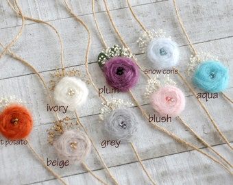 several different colors of yarn and flowers on a string with names in english, spanish, and italian