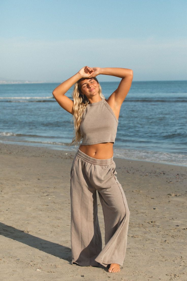 Made with cotton and a stretchy thick waistband, these pants provide the perfect fit and feel. Whether you're strolling on the beach or running errands, they are functional for everyday wear. Relaxed Fit Pants For Beach Season Loungewear, Relaxed Fit Sweatpants For Vacation, Relaxed Cotton Pants For Beach Season, Comfortable Beach Pants, Relaxed Yoga Bottoms, Comfortable Stretch Sweatpants For Summer, Casual Relaxed Fit Sweatpants For Beach, Beachy Cotton Bottoms With Relaxed Fit, Beachy Relaxed Cotton Bottoms