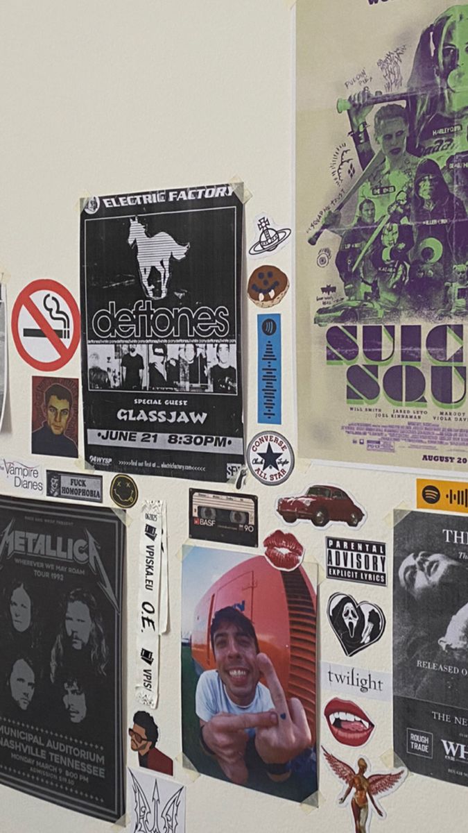 a wall covered in posters and stickers