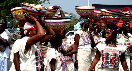 a group of women carrying baskets on their heads