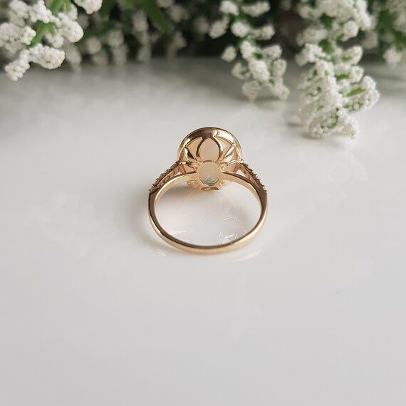 RING DETAILS:✪Design: Gold ring✪Gemstone: Natural welo opal, moissanite diamonds✪Gemstone shape: Oval✪Gemstone size: 10X12 mm✪Setting type: Prong✪Metal type: 14k solid yellow gold✪Metal finish: Smooth shinyChoose your ring size from drop down menu and if you need any other preferred ring size please contact us.**********************************QUALITY OF MATERIALS:Metal: Most of our jewelry at JewelryMansion is made with precious metals like gold and silver. These metals are 100% non-allergic to Anniversary Opal Ring Stamped 14k In Oval Shape, Gold Gemstone Cluster Ring For Proposal, Heirloom Style Gold Opal Ring With Bezel Setting, Heirloom Gold Opal Ring With Bezel Setting, Gold Opal Ring With Bezel Setting, Gold Cluster Ring For May Birthstone Gift, Gold May Birthstone Ring With Round Stone, Gold Cluster Ring With May Birthstone, Gold Topaz Ring With Halo Setting In 14k Gold