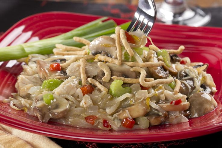 a red plate topped with pasta and veggies