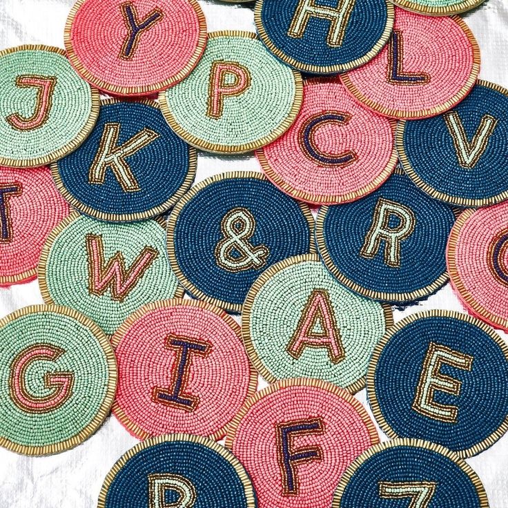 many different types of letters and numbers are on the table top with some type of fabric