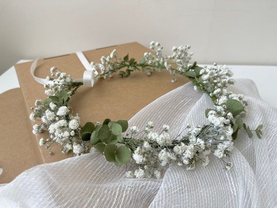 a white flower crown sitting on top of a box