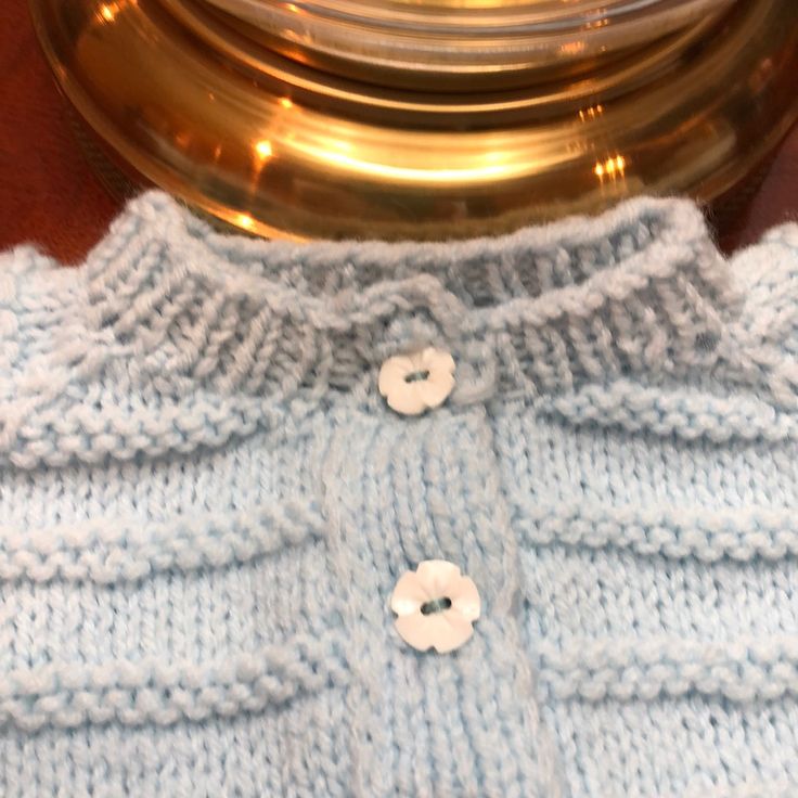 a close up of a knitted sweater with buttons