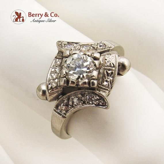 Art Deco 14 K (.585) white gold ring with a round cut Diamond centerpiece - 0.5 carat, SI-2 clarity, G color. The bezel is accented with 6 single cut Diamonds, 1.5 mm in diameter each. c. 1920. This magnificent ring is a size 6 3/4 and weighs 4.1 grams. Eb8282 Art Deco White Gold Diamond Ring With Bezel Setting, Art Deco Diamond White Ring With Bezel Setting, Art Deco White Diamond Ring With Bezel Setting, 14k White Gold Diamond Ring With Round Stone, Art Deco Silver Diamond Ring With Bezel Setting, Silver Art Deco Diamond Ring With Bezel Setting, Art Deco Diamond Ring With Bezel Setting, Art Deco Diamond Ring With Diamond Accents, Formal 14k White Gold Diamond Ring With Bezel Setting