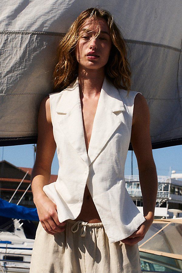 Business in the front, party in the back: this tailored linen vest features a fully open back for a daring touch. **Fit:** Relaxed **Features:** Breezy linen blend, V-neckline, single snap closure, lapel details, open back, waist tie accent **Why We | Alexandra Suit Vest Jacket by Free People in White, Size: XS Tie Women Outfit, Beach Fashion Editorial, White Linen Suit, Wedding Vest, Wedding Outfits For Women, Linen Vest, Summer Vest, Tropical Prints, Tie Women