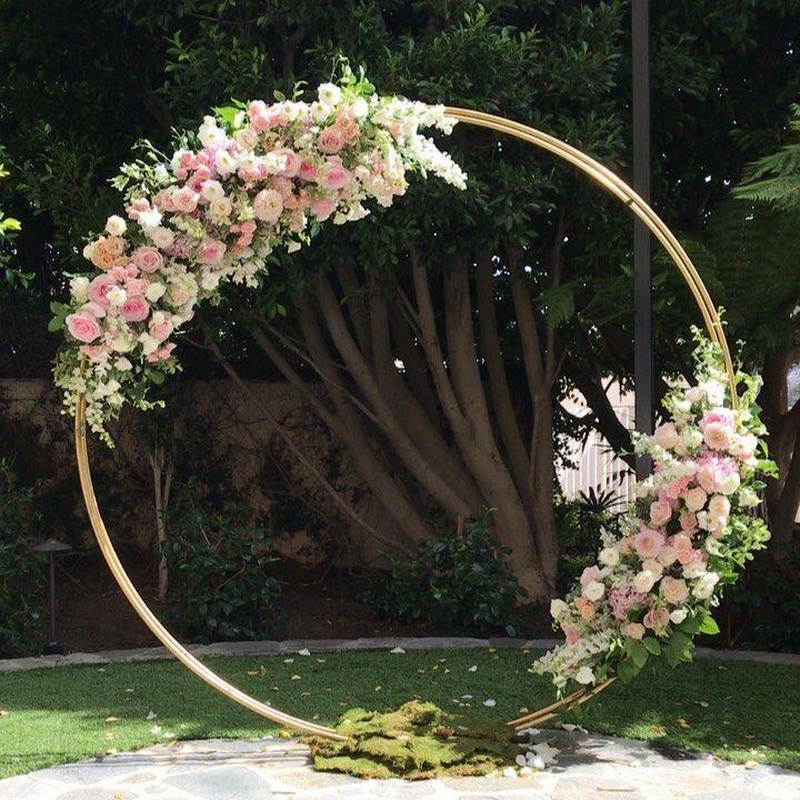 a circular wedding arch with pink and white flowers