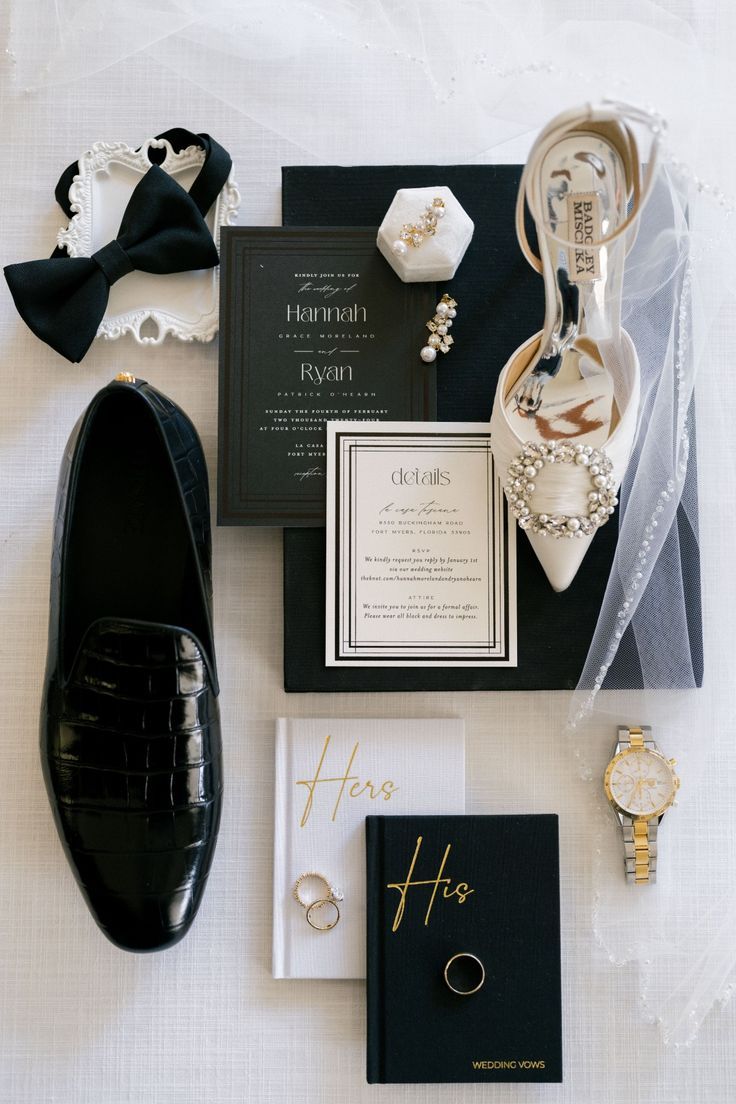 the wedding stationery is laid out neatly on top of the bride's shoes