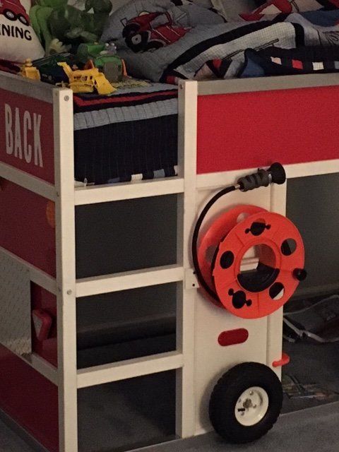 a red and white bunk bed with wheels