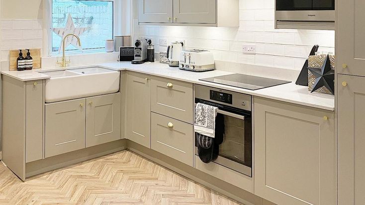 a kitchen with an oven, sink and dishwasher