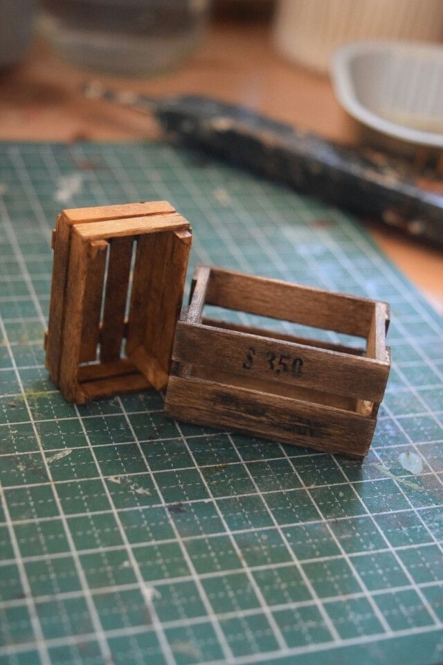 two wooden crates sitting on top of a cutting board