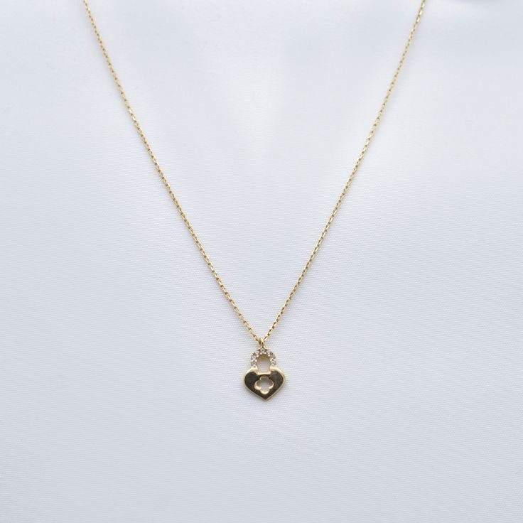 Experience the enchanting allure of our Pave Gemstones Lock Heart Pendant Necklace. Crafted in 10K solid gold, this captivating piece features a heart-shaped pendant adorned with dazzling pave gemstones, adding a touch of glamour and sophistication to any outfit. Necklace Length: 16"Pendant Size: 9 x 12 mm Elegant White Gold Heart Necklace With Gemstone, Cubic Zirconia Heart Necklace With Gemstone, Elegant Gemstone Heart Necklace For Anniversary, Elegant Heart Cut Gemstone Heart Necklace, Cubic Zirconia Heart Pendant Jewelry With Heart Beads, Fine Jewelry Diamond Heart Necklace With Gemstone, Elegant Heart Necklace With Birthstone And Cubic Zirconia, Elegant Heart Necklace With Birthstone In Cubic Zirconia, Elegant Cubic Zirconia Heart Necklace With Birthstone