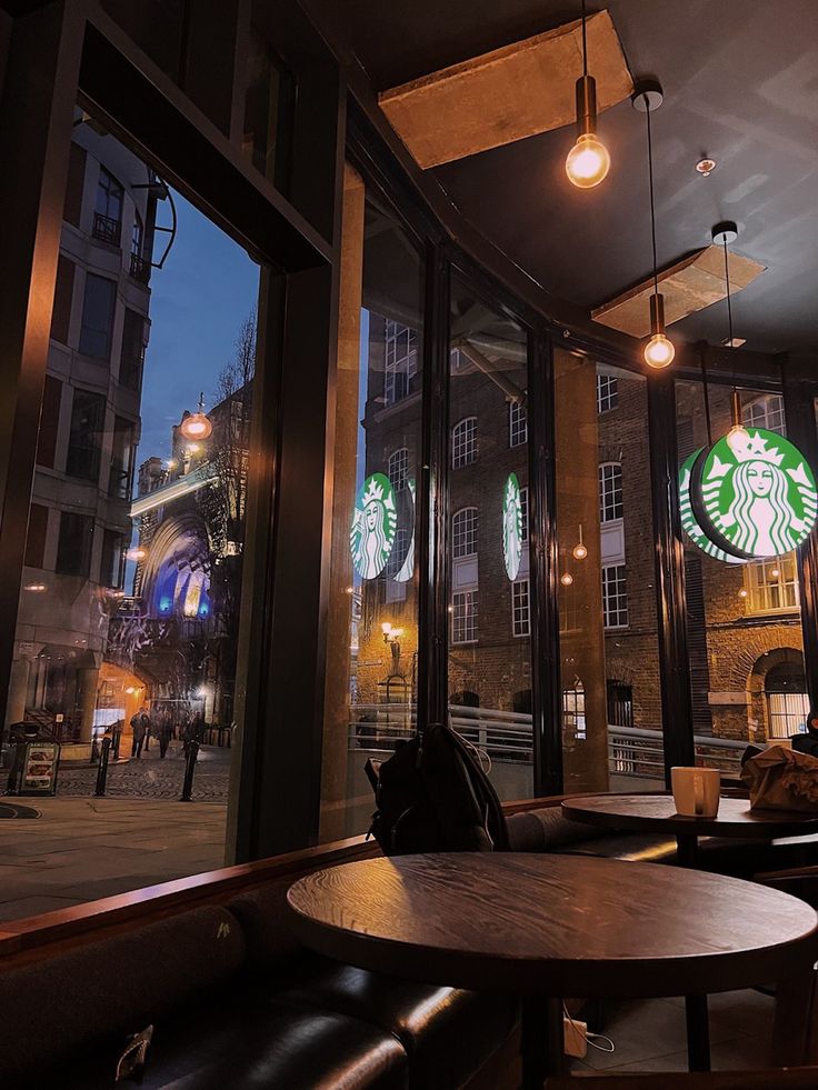 starbucks coffee shop with large windows at night