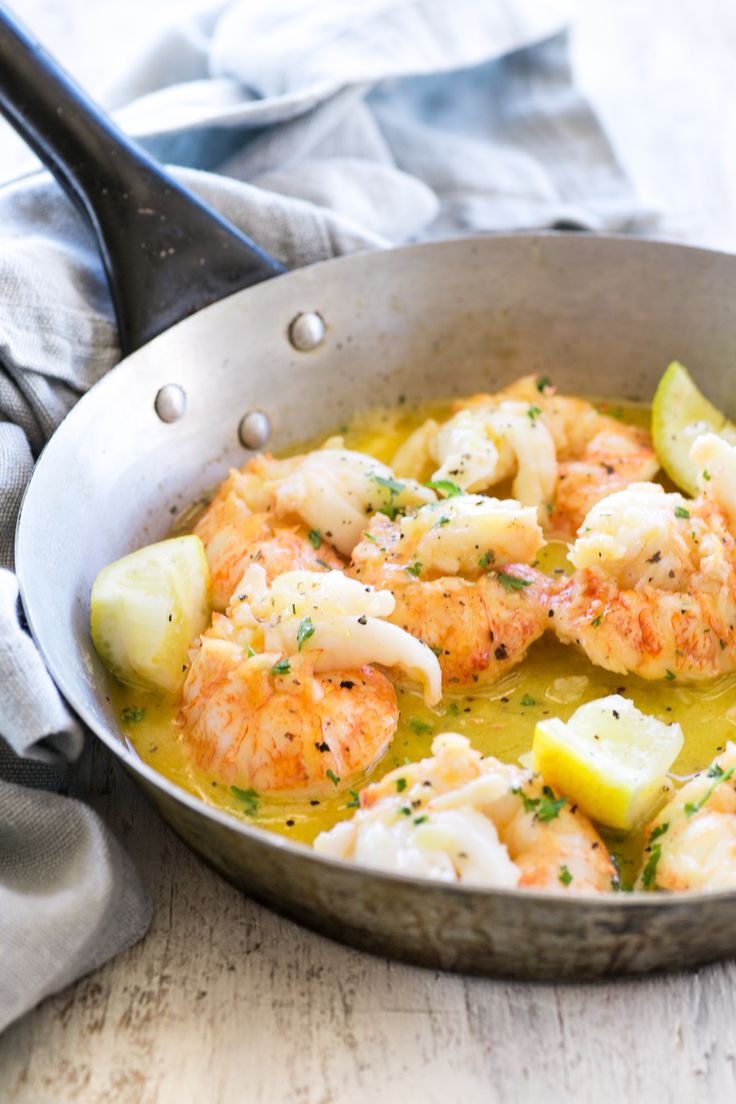 a skillet filled with shrimp and potatoes