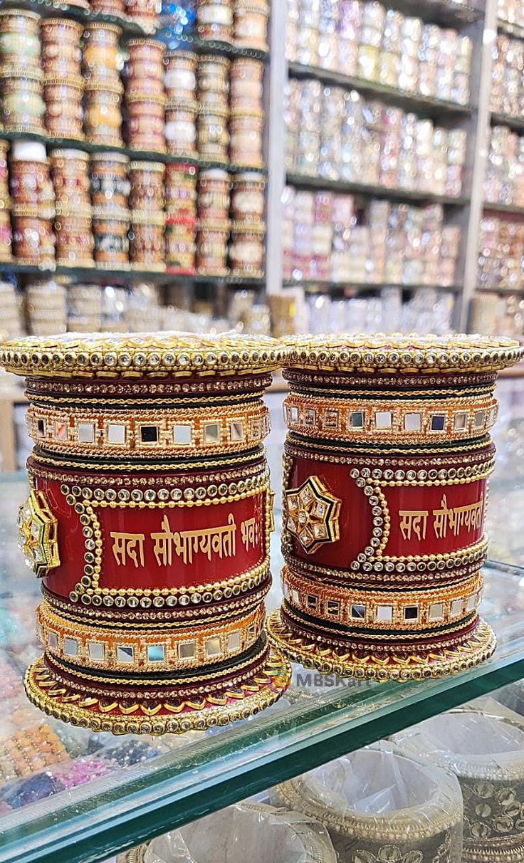 two bangles sitting on top of a glass shelf