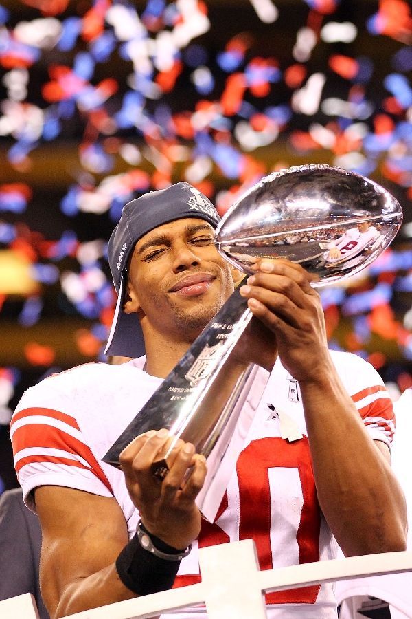 the football player is holding up his trophy