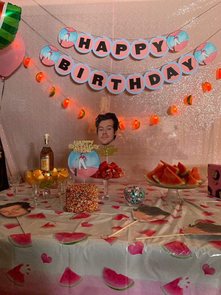 a table topped with lots of food and balloons