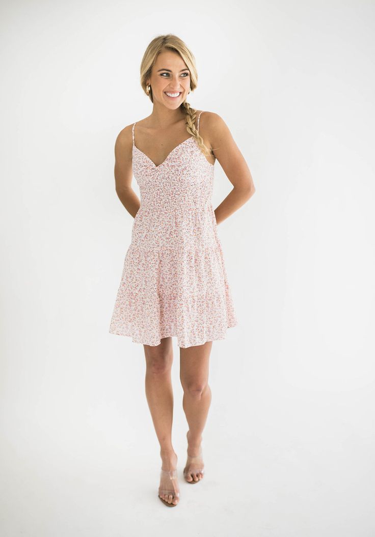 Elevate your look with our Dylan mini dress, a perfect blend of elegance and summer fun. This dress features a flattering twist front design and playful tiered layers. It has adjustable spaghetti straps that ensure a personalized fit, while the smocked back provides comfortable stretch and support. Ideal for both casual outings and special occasions, this mini dress is your go-to choice for a chic and effortless look. Size Chart Features: mini length twist front v-neck design smocking adjustable spaghetti straps lined fabric content: 100% polyester model is wearing a small. Height 5'7" Bust 34", Waist 25", Hip 36" Flowy Sundress With Ruffled Straps For Brunch, Flowy Spaghetti Strap Dress For Brunch, Flowy Mini Dress With Adjustable Ruffled Straps, Flirty Sundress With Ruffles And Spaghetti Straps, Casual Pink Tiered Dress With Ruffled Straps, Flirty Sundress With Spaghetti Straps And Ruffles, Summer Dress With Adjustable Straps And Tiered Shape, Ruffled Straps Sundress For Brunch, Ruffled Straps Sundress With Adjustable Straps