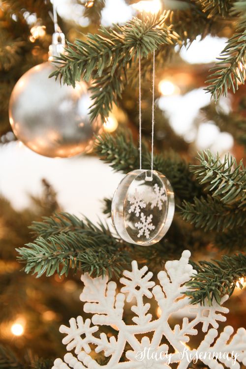 a snowflake ornament hanging from a christmas tree