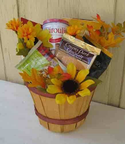 a basket filled with food and flowers on top of a table