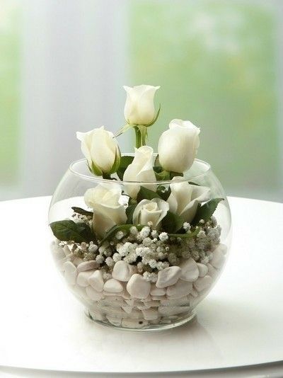 a vase filled with white flowers on top of a table