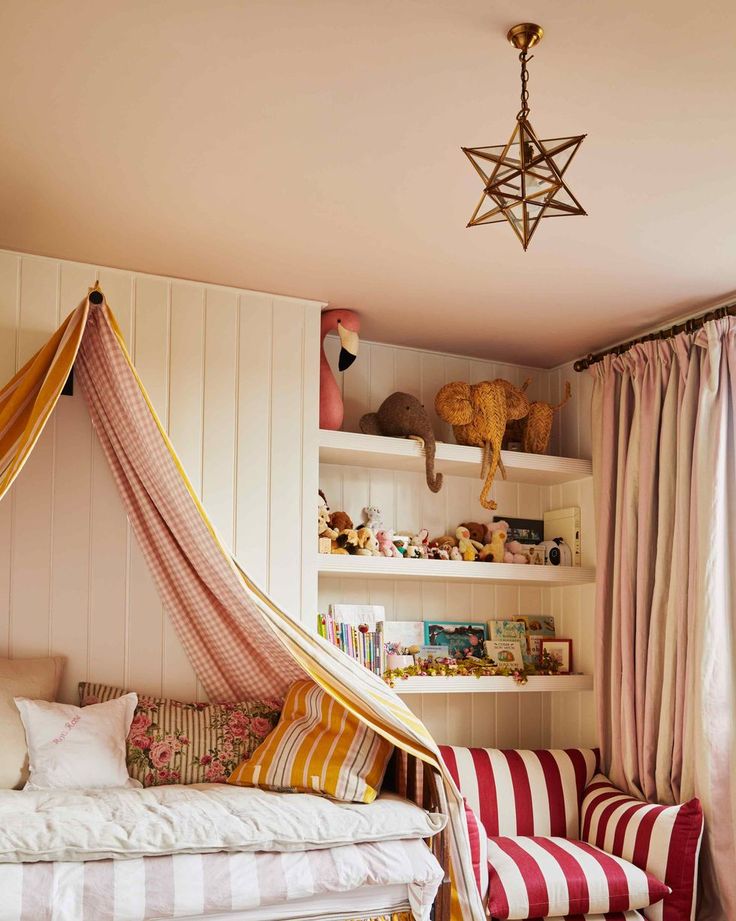 a bedroom with pink and white striped furniture