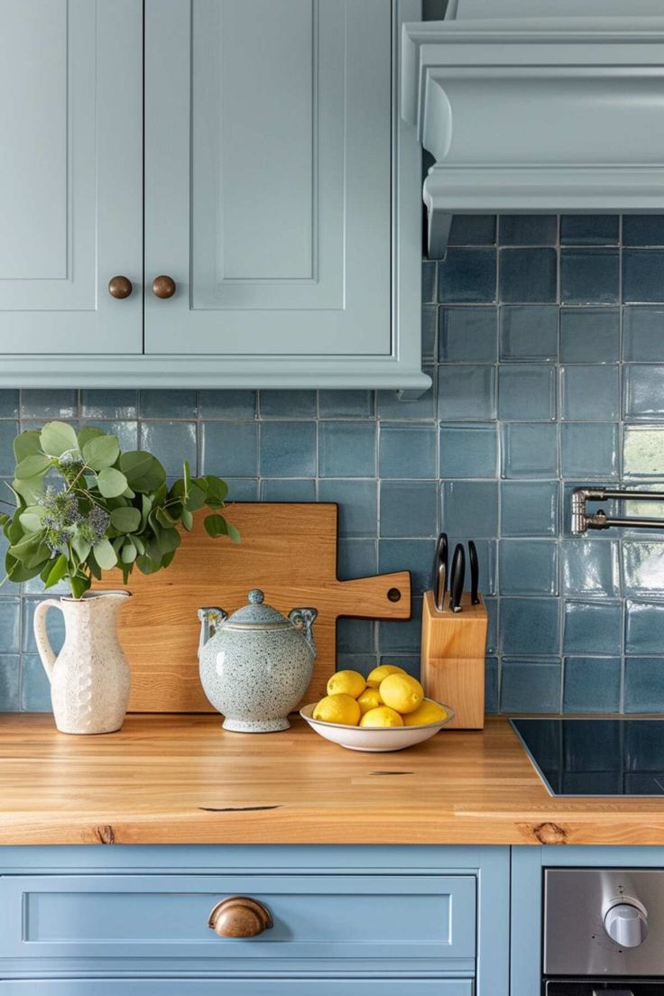 a kitchen with blue cabinets and wooden counter tops, including a bowl of lemons