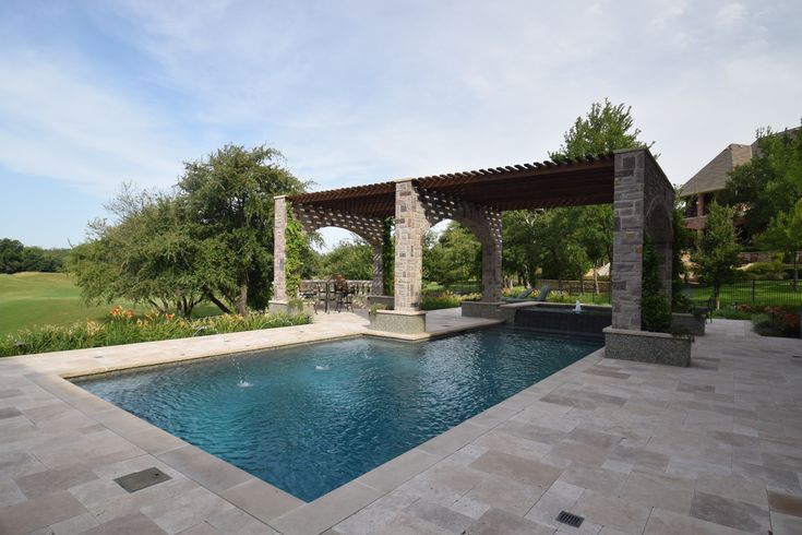 an outdoor pool with a pergolated gazebo next to it