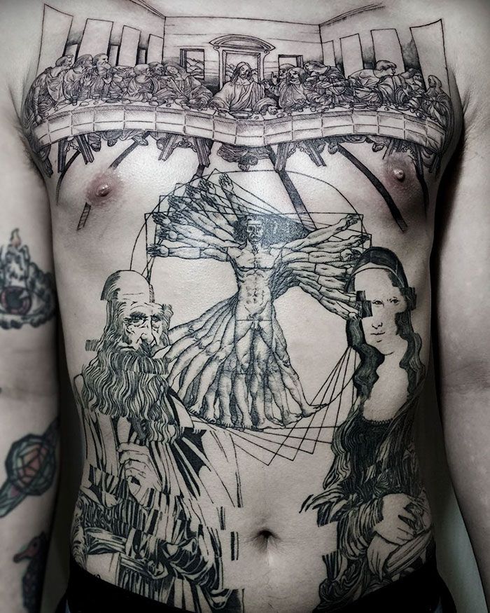 the back of a man with tattoos on his chest