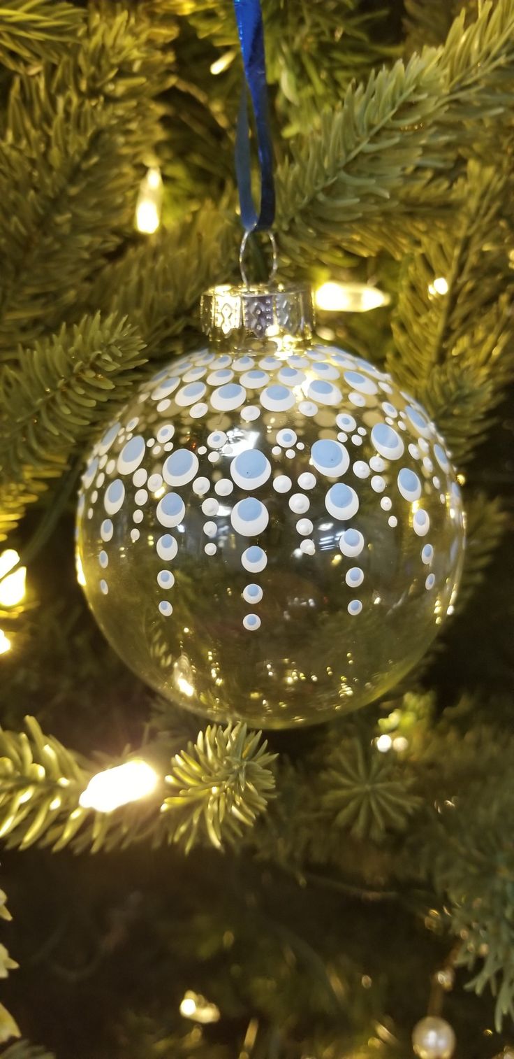 a glass ornament hanging from a christmas tree