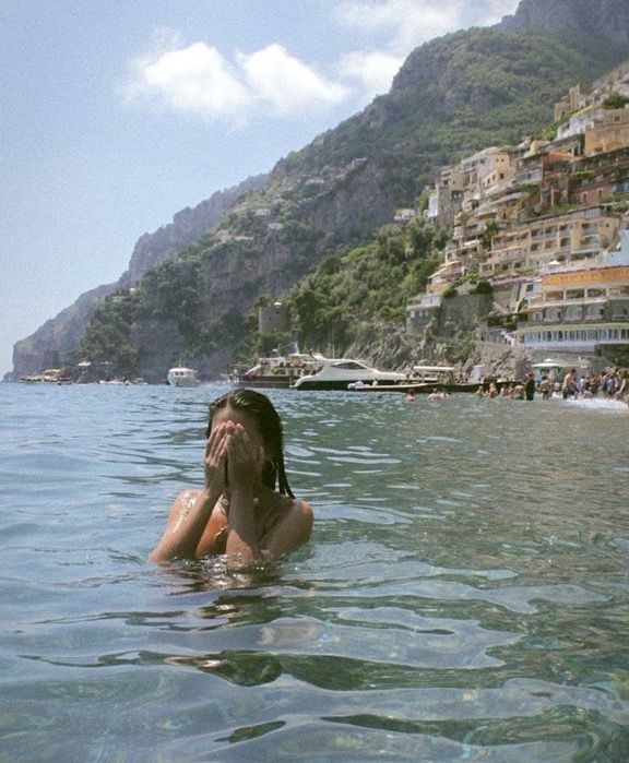 a woman is floating in the water with her head above her face