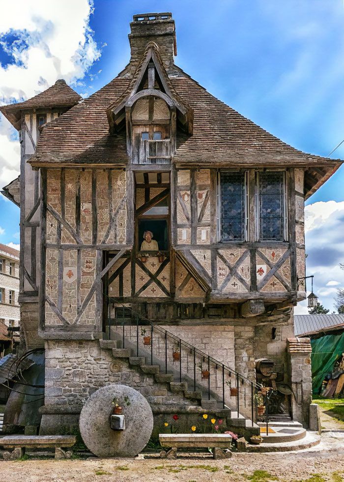 an old style house with stairs leading up to it