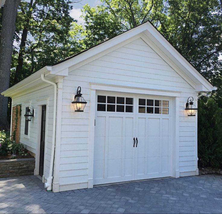 a white garage with two lights on the side